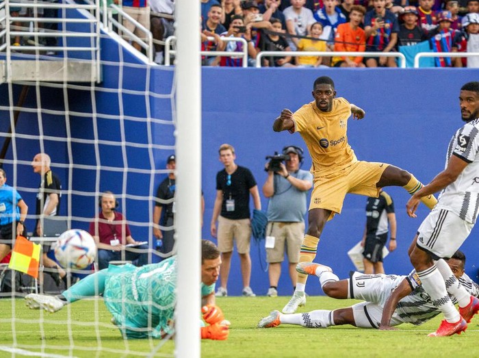 Barcelona forward Ousmane Dembélé dribbles the ball during the first half of a soccer match against Juventus at the Cotton Bowl, Tuesday, July 26, 2022 in Dallas. The game ended in a 2-2 draw. (AP Photo/Jeffrey McWhorter)