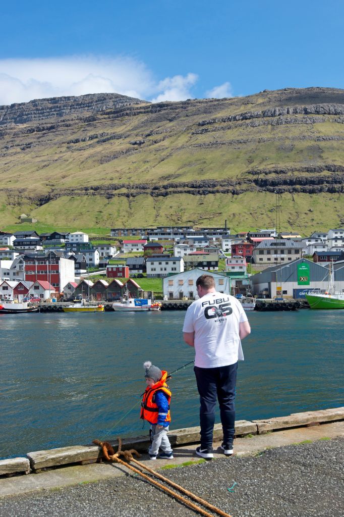 Fisherman with his son. Klaksvik harbour. Bordoy island (Nordoyar). Faroe Islands (Faroes). Denmark. Europe. (Photo by: Massimo Piacentino/REDA&CO/Universal Images Group via Getty Images)