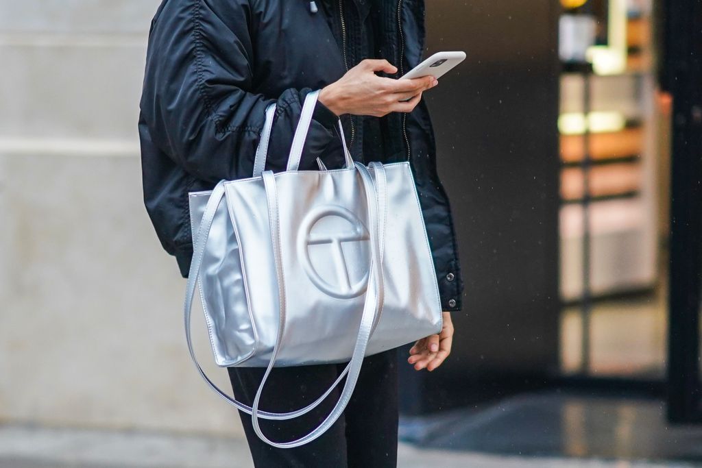 PARIS, FRANCE - DECEMBER 12: A passerby wears a black bomber jacket and a silver Telfar logo large bag, on December 12, 2020 in Paris, France. (Photo by Edward Berthelot/Getty Images)