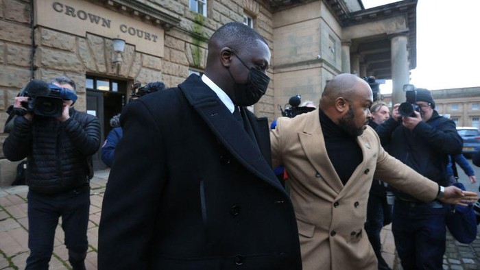 Manchester City and France international footballer Benjamin Mendy (C) leaves after a pre-trial hearing at Chester Crown Court in Chester, northwest England, on February 2, 2022. - Mendy, who has been charged with seven counts of rape, was freed on bail last month with 