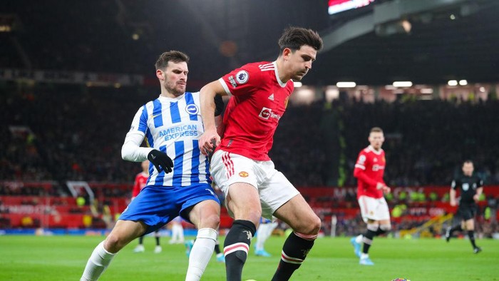 MANCHESTER, ENGLAND - FEBRUARY 15: Harry Maguire of Manchester United battles for possession with Pascal Gross of Brighton during the Premier League match between Manchester United  and  Brighton & Hove Albion at Old Trafford on February 15, 2022 in Manchester, England. (Photo by James Gill - Danehouse/Getty Images)