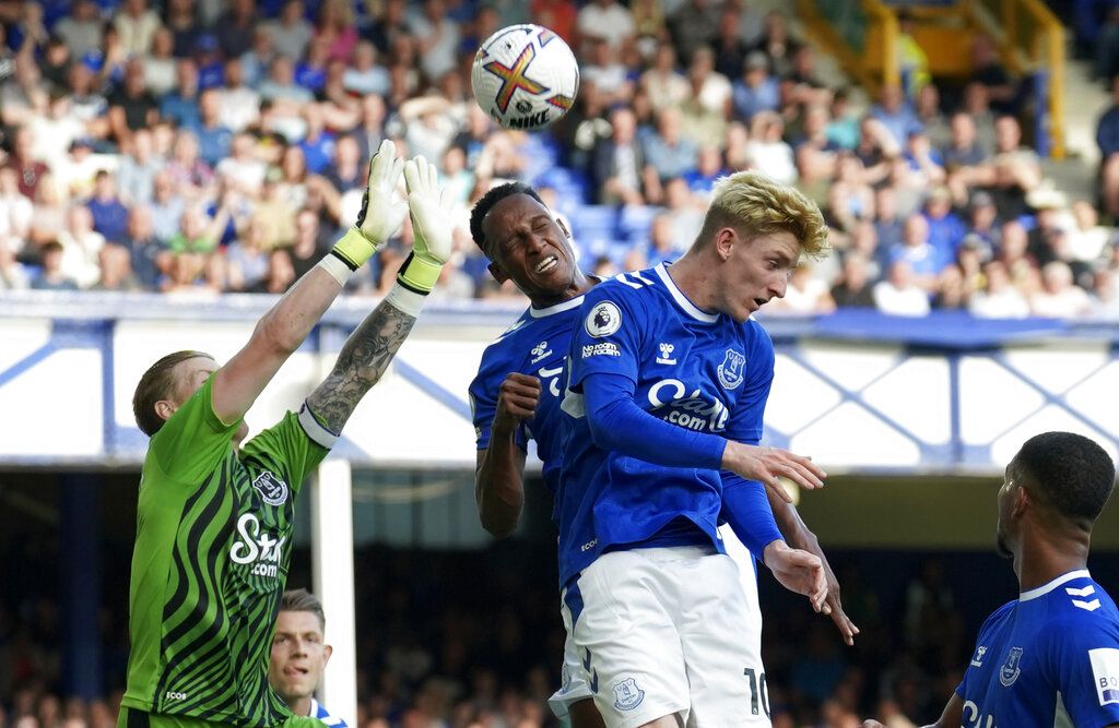 Everton's goalkeeper Jordan Pickford, left, makes a save during the English Premier League soccer match between Everton and Chelsea at Goodison Park in Liverpool, England, Saturday, Aug. 6, 2022. (AP Photo/Jon Super)