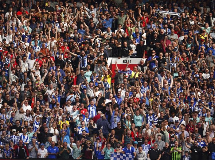 Brighton's fans celebrate after winning the English Premier League soccer match between Manchester United and Brighton at Old Trafford stadium in Manchester, England, Sunday, Aug. 7, 2022. Brighton won 2-1. (AP Photo/Dave Thompson)