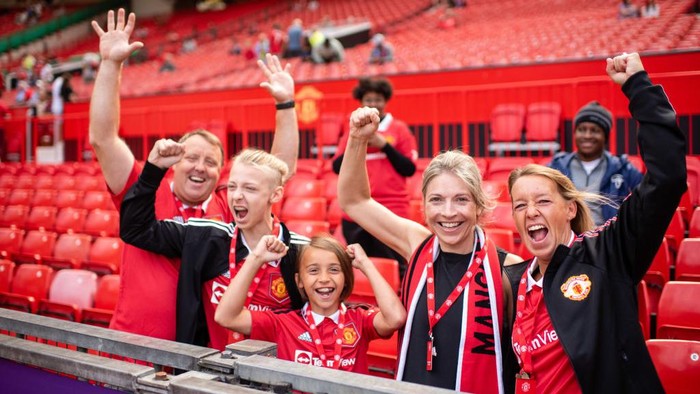 MANCHESTER, ENGLAND - AUGUST 07: Manchester United fans arrive ahead of the Premier League match between Manchester United and Brighton & Hove Albion at Old Trafford on August 07, 2022 in Manchester, England. (Photo by Ash Donelon/Manchester United via Getty Images)