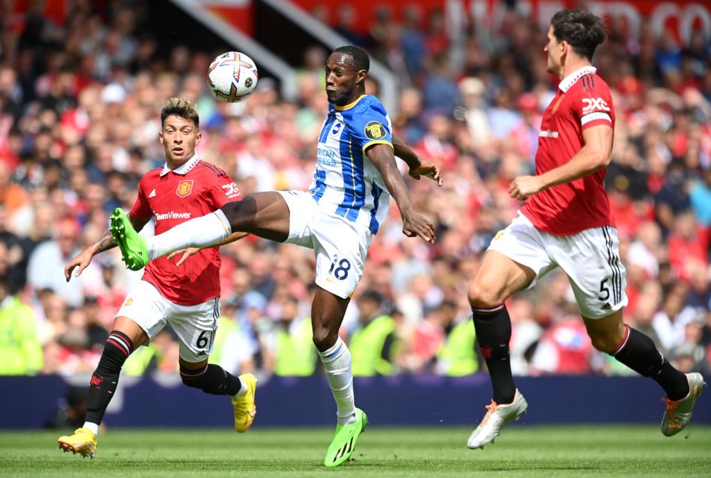 MANCHESTER, ENGLAND - AUGUST 07: Danny Welbeck of Brighton & Hove Albion is put under pressure by Lisandro Martinez (L) and Harry Maguire (R) of Manchester United during the Premier League match between Manchester United and Brighton & Hove Albion at Old Trafford on August 07, 2022 in Manchester, England. (Photo by Michael Regan/Getty Images)