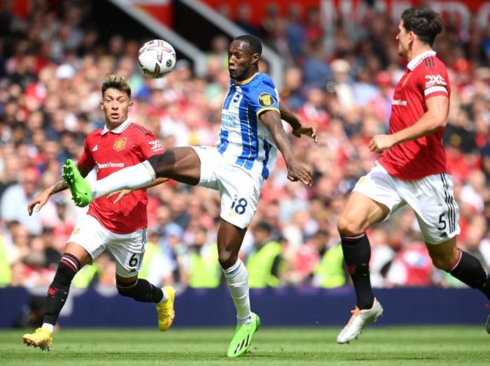 MANCHESTER, ENGLAND - AUGUST 07: Danny Welbeck of Brighton & Hove Albion is put under pressure by Lisandro Martinez (L) and Harry Maguire (R) of Manchester United during the Premier League match between Manchester United and Brighton & Hove Albion at Old Trafford on August 07, 2022 in Manchester, England. (Photo by Michael Regan/Getty Images)