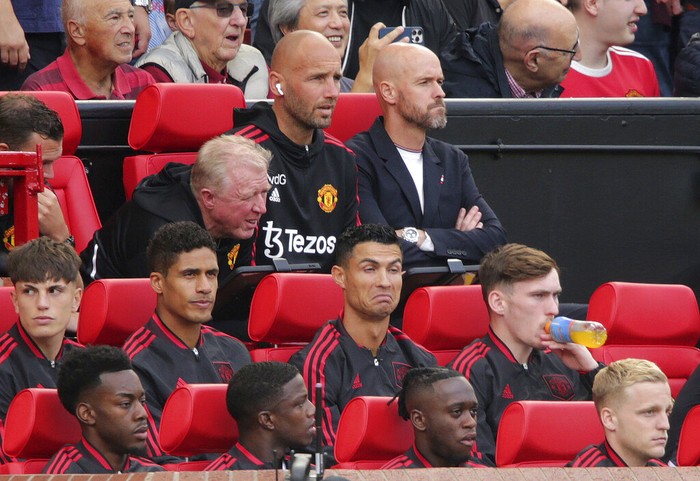 Manchester United' Cristiano Ronaldo, centre, gestures as he sits with teammates,  prior to the start of the English Premier League soccer match between Manchester United and Brighton at Old Trafford stadium in Manchester, England, Sunday, Aug. 7, 2022. (Ian Hodgson/PA via AP)