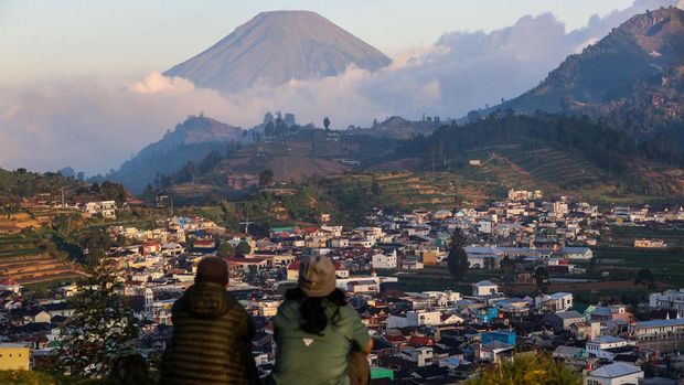 Tourists enjoy a view of the Dieng mountain area in Banjarnegara, Central Java province, Indonesia, on August 6, 2022. (Photo by Garry Lotulung/NurPhoto via Getty Images)