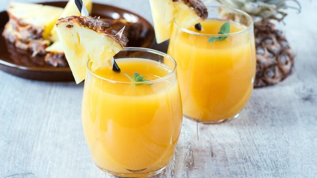 Fresh pineapple juice in the glasse,selective focus