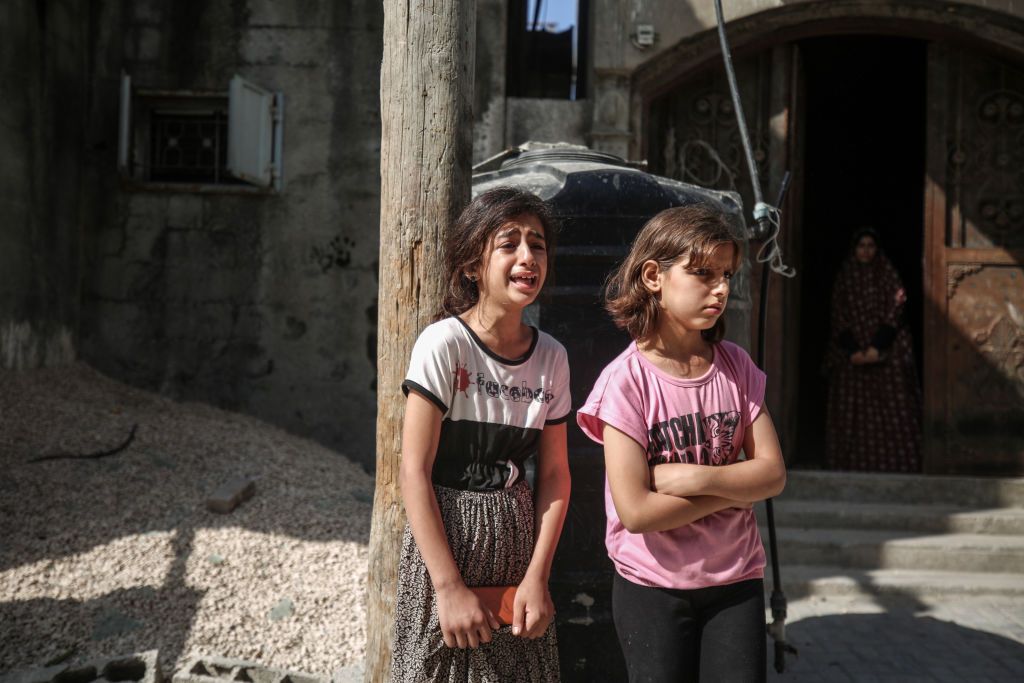 GAZA CITY, GAZA - AUGUST 7: Kids react following an Israeli airstrike on the Jabalia refugee camp, north of Gaza City, Gaza on August 7, 2022.At least 24 Palestinians have been killed in Israeli airstrikes in the Gaza Strip since Aug. 5, the Health Ministry said late Saturday. (Photo by Ali Jadallah/Anadolu Agency via Getty Images)