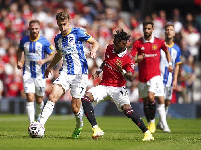 Brightons Solly March, left, challenges for the ball with Manchester Uniteds Fred during the English Premier League soccer match between Manchester United and Brighton at Old Trafford stadium in Manchester, England, Sunday, Aug. 7, 2022. (AP Photo/Dave Thompson)