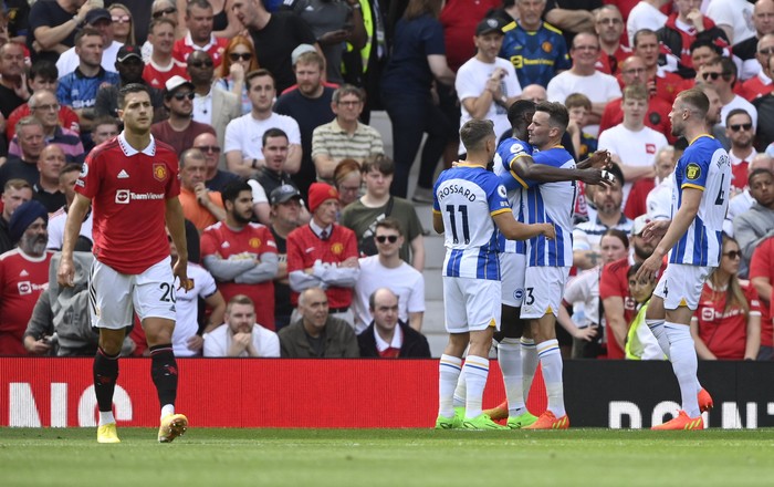 Manchester United vs Brighton Soccer Football - Premier League - Manchester United v Brighton & Hove Albion - Old Trafford, Manchester, Britain - August 7, 2022 Brighton & Hove Albion's Pascal Gross celebrates scoring their first goal with Danny Welbeck, Leandro Trossard and Adam Webster as Manchester United's Diogo Dalot looks on REUTERS/Toby Melville EDITORIAL USE ONLY. No use with unauthorized audio, video, data, fixture lists, club/league logos or 'live' services. Online in-match use limited to 75 images, no video emulation. No use in betting, games or single club /league/player publications. Please contact your account representative for further details.