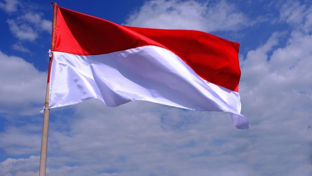 Indonesia Flag Fluttered in the Blue Sky. Indonesian Independence Day in August.