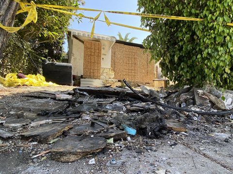 Charred debris and caution tape are seen at the site where US actress Anne Heche crashed into a home in Mar Vista, California on August 8, 2022. - US actress Anne Heche has been hospitalized in critical condition after crashing her car into a Los Angeles home, US media reported on August 5, 2022. The 53-year-old actress initially crashed into an apartment building garage before driving off, according to images collected by TMZ. (Photo by Chris Delmas / AFP)
