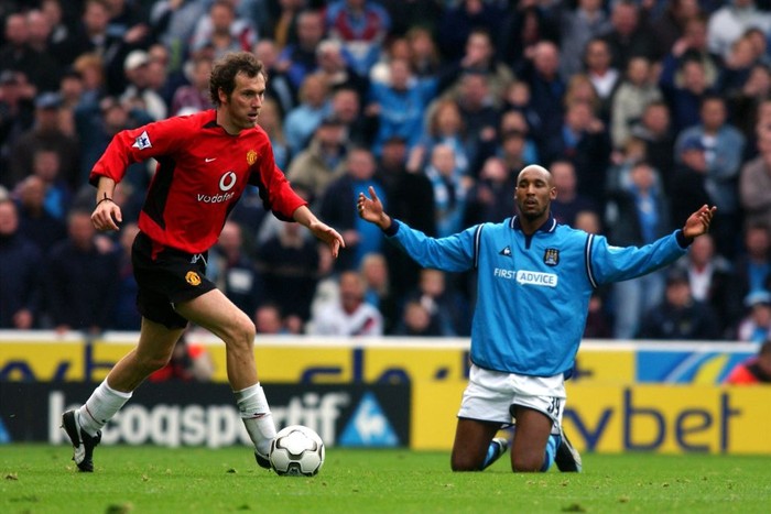 Manchester United's Laurent Blanc dribbles the ball past Manchester City's Nicolas Anelka who remains on the turf following a challenge  (Photo by Neal Simpson/EMPICS via Getty Images)