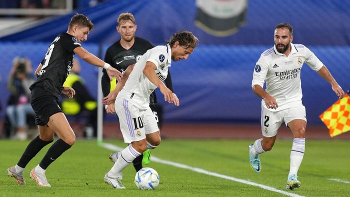 Real Madrid's Luka Modric, right, is challenged by Frankfurt's Jesper Lindstrom during the UEFA Super Cup final soccer match between Real Madrid and Eintracht Frankfurt at Helsinki's Olympic Stadium, Finland, Wednesday, Aug. 10, 2022. (AP Photo/Antonio Calanni)