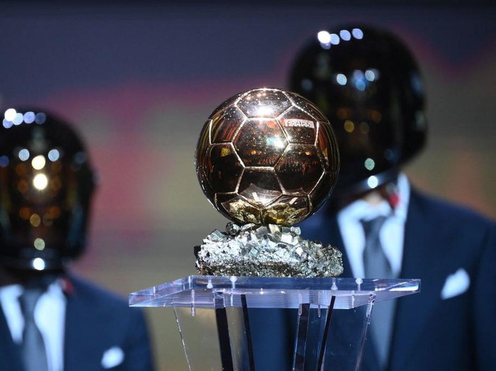 Formula One drivers Fernando Alonso of Spain and Esteban Ocon of France present the trophy for the the Ballon d'Or award during the 2021 Ballon d'Or France Football award ceremony at the Theatre du Chatelet in Paris on November 29, 2021. (Photo by FRANCK FIFE / AFP) (Photo by FRANCK FIFE/AFP via Getty Images)