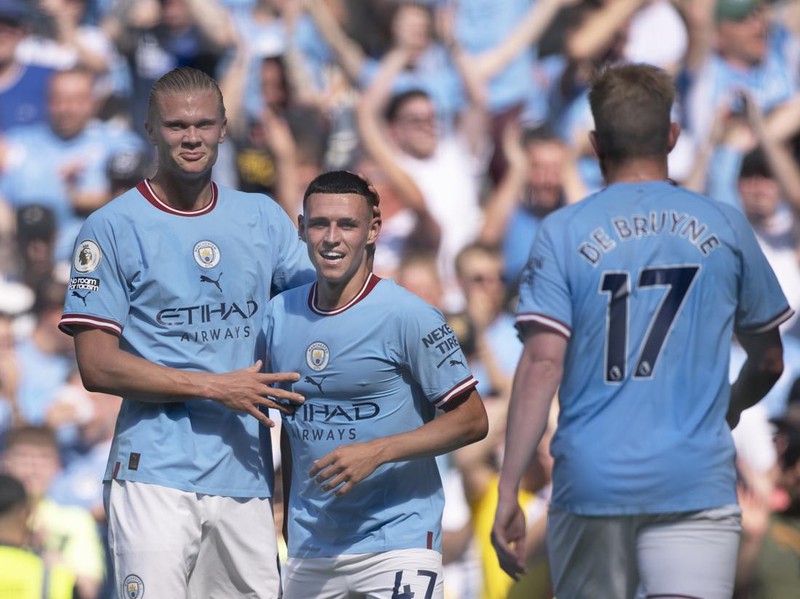 MANCHESTER, ENGLAND - AUGUST 13: Phil Foden of Manchester City celebrates scoring with team mates Erling Haaland and Kevin De Bruyne during the Premier League match between Manchester City and AFC Bournemouth at Etihad Stadium on August 13, 2022 in Manchester, United Kingdom. (Photo by Joe Prior/Visionhaus via Getty Images)