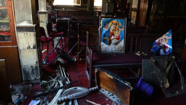 Burned furniture, including wooden tables and chairs, and a religious images are seen at the site of a fire inside the Abu Sefein Coptic church that killed at least 40 people and injured some 14 others, in the densely populated neighborhood of Imbaba, Cairo Egypt, Sunday, Aug. 14, 2022. The church said the fire broke out while a service was underway. The cause of the blaze was not immediately known. An initial investigation pointed to an electrical short-circuit, according to a police statement. (AP Photo/Tarek Wajeh)