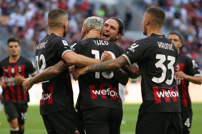 MILAN, ITALY - AUGUST 13: Theo Hernandez of AC Milan celebrates with team mates after scoring a first half penalty to level the game at 1-1 during the Serie A match between AC Milan and Udinese Calcio at Stadio Giuseppe Meazza on August 13, 2022 in Milan, Italy. (Photo by Jonathan Moscrop/Getty Images)