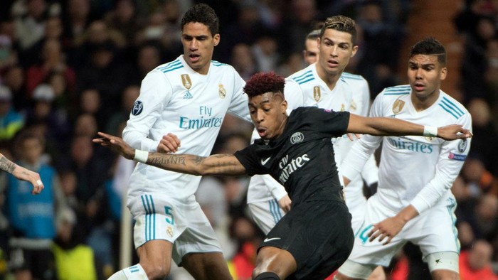 Raphael Varane, Cristiano Ronaldo, Casemiro Paris Saint-Germain's French defender Presnel Kimpembe (front) kicks the ball beside Real Madrid's French defender Raphael Varane, Real Madrid's Portuguese forward Cristiano Ronaldo and Real Madrid's Brazilian midfielder Casemiro (back L-R) during the UEFA Champions League round of sixteen first leg football match Real Madrid CF against Paris Saint-Germain (PSG) at the Santiago Bernabeu stadium in Madrid on February 14, 2018. / AFP PHOTO / CURTO DE LA TORRE (Photo credit should read CURTO DE LA TORRE/AFP via Getty Images)