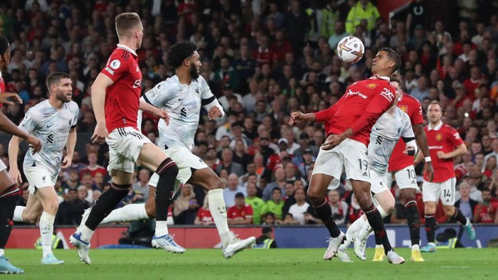MANCHESTER, ENGLAND - AUGUST 22: Raphael Varane of Manchester United in action with Joe Gomez of Liverpool during the Premier League match between Manchester United and Liverpool FC at Old Trafford on August 22, 2022 in Manchester, England. (Photo by Tom Purslow/Manchester United via Getty Images)