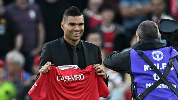 Manchester Uniteds Brazilian midfielder Casemiro is photographed with a United shirt as he is introduced to supporters ahead of the English Premier League football match between Manchester United and Liverpool at Old Trafford in Manchester, north west England, on August 22, 2022. - RESTRICTED TO EDITORIAL USE. No use with unauthorized audio, video, data, fixture lists, club/league logos or live services. Online in-match use limited to 120 images. An additional 40 images may be used in extra time. No video emulation. Social media in-match use limited to 120 images. An additional 40 images may be used in extra time. No use in betting publications, games or single club/league/player publications. (Photo by Paul ELLIS / AFP) / RESTRICTED TO EDITORIAL USE. No use with unauthorized audio, video, data, fixture lists, club/league logos or live services. Online in-match use limited to 120 images. An additional 40 images may be used in extra time. No video emulation. Social media in-match use limited to 120 images. An additional 40 images may be used in extra time. No use in betting publications, games or single club/league/player publications. / RESTRICTED TO EDITORIAL USE. No use with unauthorized audio, video, data, fixture lists, club/league logos or live services. Online in-match use limited to 120 images. An additional 40 images may be used in extra time. No video emulation. Social media in-match use limited to 120 images. An additional 40 images may be used in extra time. No use in betting publications, games or single club/league/player publications. (Photo by PAUL ELLIS/AFP via Getty Images)