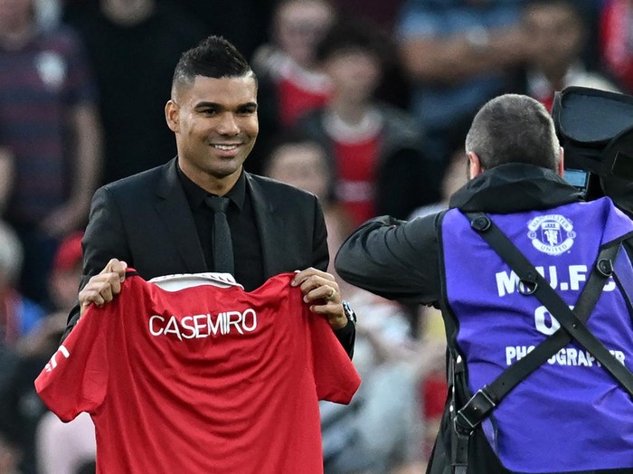 Manchester United's Brazilian midfielder Casemiro is photographed with a United shirt as he is introduced to supporters ahead of the English Premier League football match between Manchester United and Liverpool at Old Trafford in Manchester, north west England, on August 22, 2022. - RESTRICTED TO EDITORIAL USE. No use with unauthorized audio, video, data, fixture lists, club/league logos or 'live' services. Online in-match use limited to 120 images. An additional 40 images may be used in extra time. No video emulation. Social media in-match use limited to 120 images. An additional 40 images may be used in extra time. No use in betting publications, games or single club/league/player publications. (Photo by Paul ELLIS / AFP) / RESTRICTED TO EDITORIAL USE. No use with unauthorized audio, video, data, fixture lists, club/league logos or 'live' services. Online in-match use limited to 120 images. An additional 40 images may be used in extra time. No video emulation. Social media in-match use limited to 120 images. An additional 40 images may be used in extra time. No use in betting publications, games or single club/league/player publications. / RESTRICTED TO EDITORIAL USE. No use with unauthorized audio, video, data, fixture lists, club/league logos or 'live' services. Online in-match use limited to 120 images. An additional 40 images may be used in extra time. No video emulation. Social media in-match use limited to 120 images. An additional 40 images may be used in extra time. No use in betting publications, games or single club/league/player publications. (Photo by PAUL ELLIS/AFP via Getty Images)