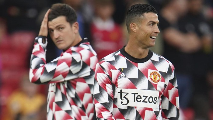 Manchester Uniteds Cristiano Ronaldo and Manchester Uniteds Harry Maguire warm up prior to the start of the English Premier League soccer match between Manchester United and Liverpool at Old Trafford stadium, in Manchester, England, Monday, Aug 22, 2022. (AP Photo/Dave Thompson)