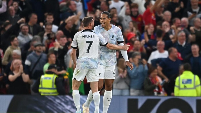 MANCHESTER, ENGLAND - AUGUST 22: James Milner of Liverpool interacts with teammate Virgil van Dijk after the Manchester United first goal scored by Jadon Sancho (Not pictured) during the Premier League match between Manchester United and Liverpool FC at Old Trafford on August 22, 2022 in Manchester, England. (Photo by Michael Regan/Getty Images)