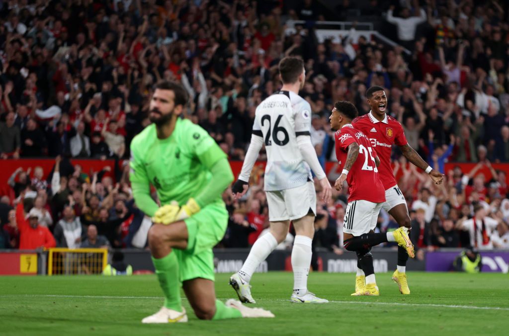 MANCHESTER, ENGLAND - AUGUST 22: Jadon Sancho of Manchester United celebrates with teammate Marcus Rashford after scoring their side's first goal as Alisson Becker of Liverpool looks dejected  during the Premier League match between Manchester United and Liverpool FC at Old Trafford on August 22, 2022 in Manchester, England. (Photo by Clive Brunskill/Getty Images)