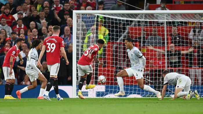 MANCHESTER, ENGLAND - AUGUST 22: Jadon Sancho of Manchester United scores their sides first goal during the Premier League match between Manchester United and Liverpool FC at Old Trafford on August 22, 2022 in Manchester, England. (Photo by Michael Regan/Getty Images)