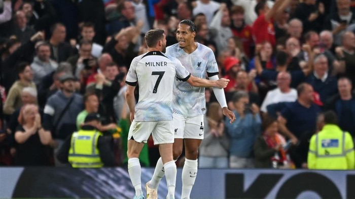 MANCHESTER, ENGLAND - AUGUST 22: James Milner of Liverpool interacts with teammate Virgil van Dijk after the Manchester United first goal scored by Jadon Sancho (Not pictured) during the Premier League match between Manchester United and Liverpool FC at Old Trafford on August 22, 2022 in Manchester, England. (Photo by Michael Regan/Getty Images)
