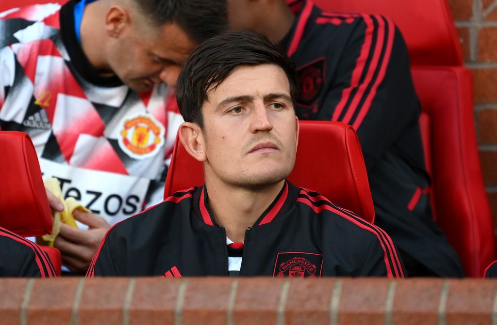 MANCHESTER, ENGLAND - AUGUST 22: Harry Maguire of Manchester United looks on from the substitutes bench prior to the Premier League match between Manchester United and Liverpool FC at Old Trafford on August 22, 2022 in Manchester, England. (Photo by Michael Regan/Getty Images)