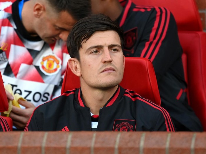 MANCHESTER, ENGLAND - AUGUST 22: Harry Maguire of Manchester United looks on from the substitutes bench prior to the Premier League match between Manchester United and Liverpool FC at Old Trafford on August 22, 2022 in Manchester, England. (Photo by Michael Regan/Getty Images)