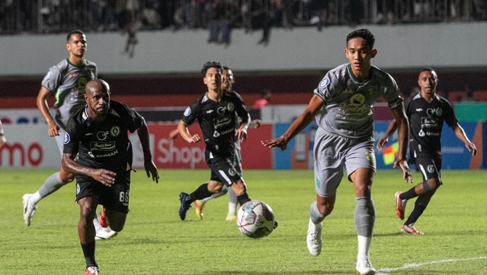 Pesepak bola PSS Sleman Boaz Salossa (kiri) berebut bola dengan pesepak bola Persebaya Surabaya Rizky Ridho (kanan) pada pertandingan Liga 1 di Stadion Maguwoharjo, Sleman, DI Yogyakarta, Sabtu (27/8/2022). ANTARA FOTO/Hendra Nurdiyansyah/wsj.