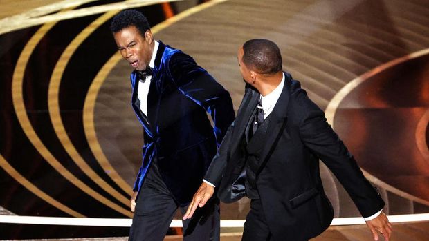 HOLLYWOOD, CA - March 27, 2022.    Will Smith slaps Chris Rock onstage during the show  at the 94th Academy Awards at the Dolby Theatre at Ovation Hollywood on Sunday, March 27, 2022.  (Myung Chun / Los Angeles Times via Getty Images)