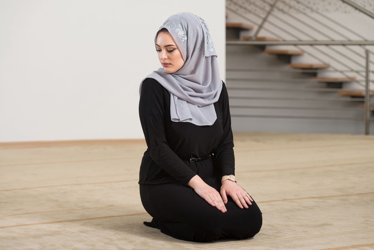 Caucasian Female Muslim Woman Wearing Black Dress And Praying In Mosque