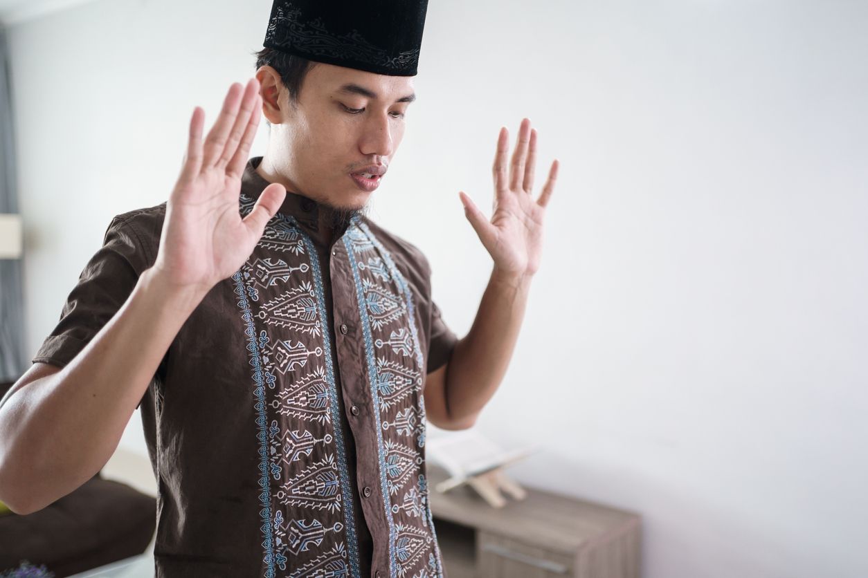 Young asian Muslim man praying at home. takbir before start the prayer