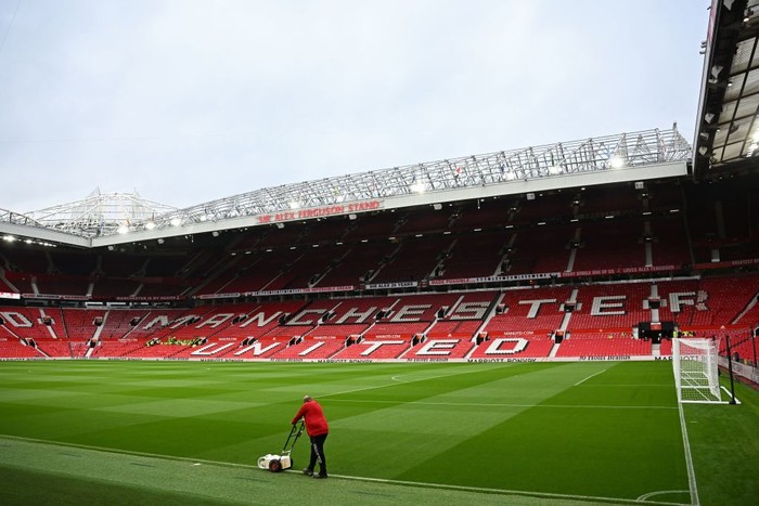 A groundsman paints the lines as final preparations are done ahead of the English Premier League football match between Manchester United and Liverpool at Old Trafford in Manchester, north west England, on August 22, 2022. - RESTRICTED TO EDITORIAL USE. No use with unauthorized audio, video, data, fixture lists, club/league logos or live services. Online in-match use limited to 120 images. An additional 40 images may be used in extra time. No video emulation. Social media in-match use limited to 120 images. An additional 40 images may be used in extra time. No use in betting publications, games or single club/league/player publications. (Photo by Paul ELLIS / AFP) / RESTRICTED TO EDITORIAL USE. No use with unauthorized audio, video, data, fixture lists, club/league logos or live services. Online in-match use limited to 120 images. An additional 40 images may be used in extra time. No video emulation. Social media in-match use limited to 120 images. An additional 40 images may be used in extra time. No use in betting publications, games or single club/league/player publications. / RESTRICTED TO EDITORIAL USE. No use with unauthorized audio, video, data, fixture lists, club/league logos or live services. Online in-match use limited to 120 images. An additional 40 images may be used in extra time. No video emulation. Social media in-match use limited to 120 images. An additional 40 images may be used in extra time. No use in betting publications, games or single club/league/player publications. (Photo by PAUL ELLIS/AFP via Getty Images)
