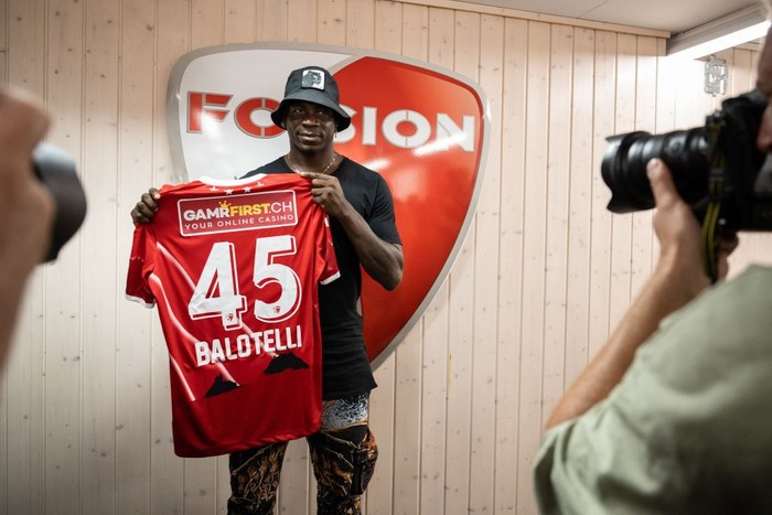 Italy's football striker Mario Balotelli poses with his new jersey on September 1, 2022, after he signed a two-year contract with Swiss side FC Sion, the 11th club of his career. - Sion will become Balotelli's fifth club since January 2019, when he attempted to relaunch his career with Marseille after two successful seasons at Nice. (Photo by Fabrice COFFRINI / AFP) (Photo by FABRICE COFFRINI/AFP via Getty Images)
