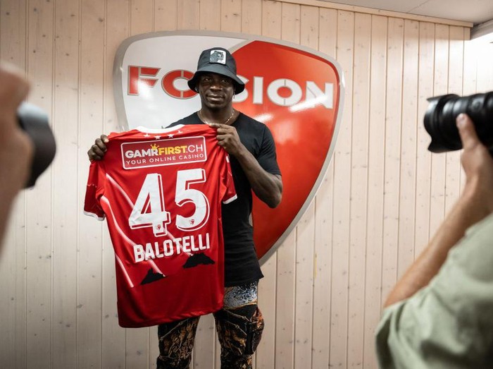 Italy's football striker Mario Balotelli poses with his new jersey on September 1, 2022, after he signed a two-year contract with Swiss side FC Sion, the 11th club of his career. - Sion will become Balotelli's fifth club since January 2019, when he attempted to relaunch his career with Marseille after two successful seasons at Nice. (Photo by Fabrice COFFRINI / AFP) (Photo by FABRICE COFFRINI/AFP via Getty Images)