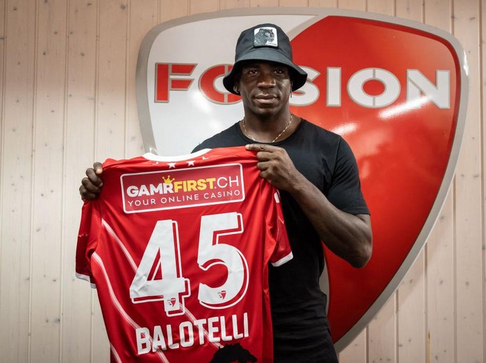 Italy's football striker Mario Balotelli poses with his new jersey on September 1, 2022, after he signed a two-year contract with Swiss side FC Sion, the 11th club of his career. - Sion will become Balotelli's fifth club since January 2019, when he attempted to relaunch his career with Marseille after two successful seasons at Nice. (Photo by Fabrice COFFRINI / AFP) (Photo by FABRICE COFFRINI/AFP via Getty Images)