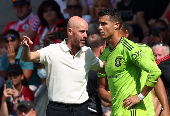 TOPSHOT - Manchester Uniteds Dutch manager Erik ten Hag (L) directs substitute Manchester Uniteds Portuguese striker Cristiano Ronaldo during the English Premier League football match between Southampton and Manchester United at St Marys Stadium in Southampton, southern England on August 27, 2022. - RESTRICTED TO EDITORIAL USE. No use with unauthorized audio, video, data, fixture lists, club/league logos or live services. Online in-match use limited to 120 images. An additional 40 images may be used in extra time. No video emulation. Social media in-match use limited to 120 images. An additional 40 images may be used in extra time. No use in betting publications, games or single club/league/player publications. (Photo by Adrian DENNIS / AFP) / RESTRICTED TO EDITORIAL USE. No use with unauthorized audio, video, data, fixture lists, club/league logos or live services. Online in-match use limited to 120 images. An additional 40 images may be used in extra time. No video emulation. Social media in-match use limited to 120 images. An additional 40 images may be used in extra time. No use in betting publications, games or single club/league/player publications. / RESTRICTED TO EDITORIAL USE. No use with unauthorized audio, video, data, fixture lists, club/league logos or live services. Online in-match use limited to 120 images. An additional 40 images may be used in extra time. No video emulation. Social media in-match use limited to 120 images. An additional 40 images may be used in extra time. No use in betting publications, games or single club/league/player publications. (Photo by ADRIAN DENNIS/AFP via Getty Images)