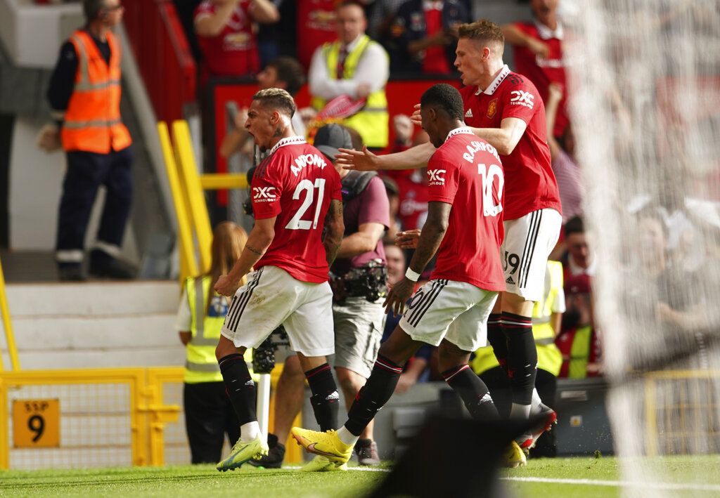 Manchester United's Antony, left, celebrates after scoring his side's opening goal during the English Premier League soccer match between Manchester United and Arsenal at Old Trafford stadium, in Manchester, England, Sunday, Sept. 4, 2022. (AP Photo/Dave Thompson)