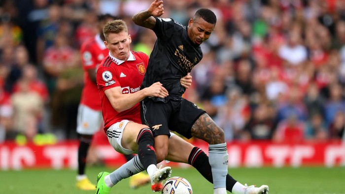 MANCHESTER, ENGLAND - SEPTEMBER 04: Scott McTominay of Manchester United tackles Gabriel Jesus of Arsenal during the Premier League match between Manchester United and Arsenal FC at Old Trafford on September 04, 2022 in Manchester, England. (Photo by Shaun Botterill/Getty Images)