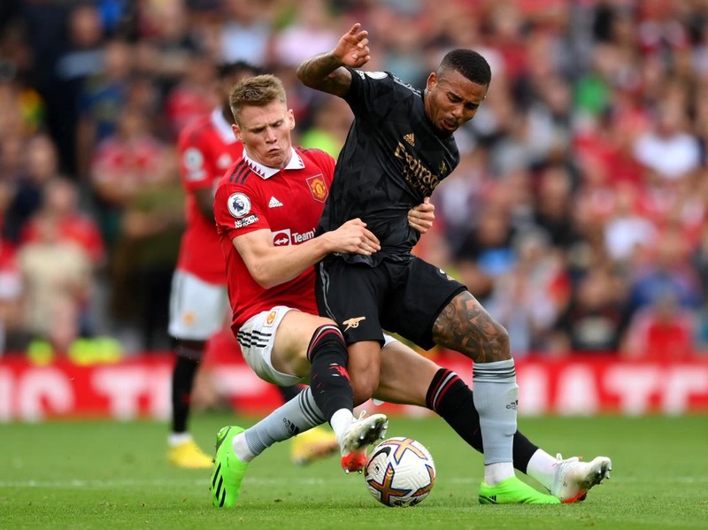 MANCHESTER, ENGLAND - SEPTEMBER 04: Scott McTominay of Manchester United tackles Gabriel Jesus of Arsenal during the Premier League match between Manchester United and Arsenal FC at Old Trafford on September 04, 2022 in Manchester, England. (Photo by Shaun Botterill/Getty Images)