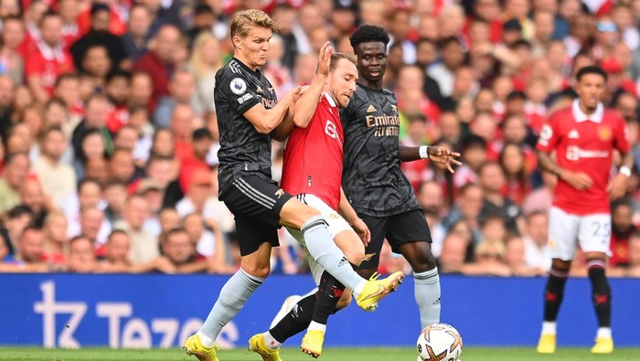MANCHESTER, ENGLAND - SEPTEMBER 04: Christian Eriksen of Manchester United is fouled by Martin Oedegaard of Arsenal during the Premier League match between Manchester United and Arsenal FC at Old Trafford on September 04, 2022 in Manchester, England. (Photo by Michael Regan/Getty Images)