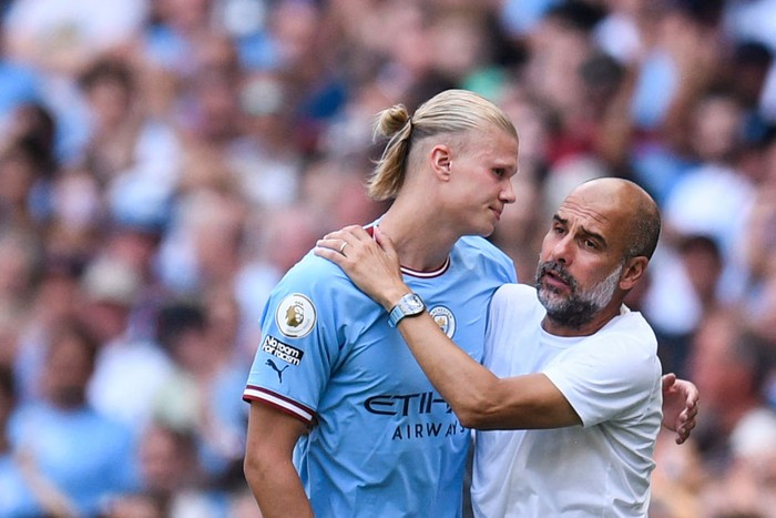 Manchester Citys Spanish manager Pep Guardiola (R) congratulates Manchester Citys Norwegian striker Erling Haaland as he leaves the pitch during the English Premier League football match between Manchester City and Bournemouth at the Etihad Stadium in Manchester, north west England, on August 13, 2022. - RESTRICTED TO EDITORIAL USE. No use with unauthorized audio, video, data, fixture lists, club/league logos or live services. Online in-match use limited to 120 images. An additional 40 images may be used in extra time. No video emulation. Social media in-match use limited to 120 images. An additional 40 images may be used in extra time. No use in betting publications, games or single club/league/player publications. (Photo by Oli SCARFF / AFP) / RESTRICTED TO EDITORIAL USE. No use with unauthorized audio, video, data, fixture lists, club/league logos or live services. Online in-match use limited to 120 images. An additional 40 images may be used in extra time. No video emulation. Social media in-match use limited to 120 images. An additional 40 images may be used in extra time. No use in betting publications, games or single club/league/player publications. / RESTRICTED TO EDITORIAL USE. No use with unauthorized audio, video, data, fixture lists, club/league logos or live services. Online in-match use limited to 120 images. An additional 40 images may be used in extra time. No video emulation. Social media in-match use limited to 120 images. An additional 40 images may be used in extra time. No use in betting publications, games or single club/league/player publications. (Photo by OLI SCARFF/AFP via Getty Images)
