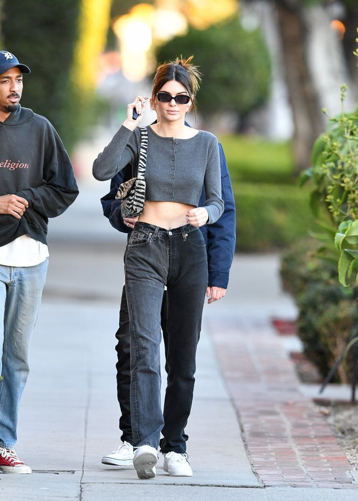 Kendall Jenner wearing washed off two-tone pants in grey and black